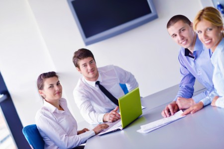 Group of happy young business people in a meeting at office